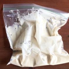 a bag of white powder sitting on top of a wooden table