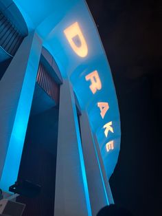 the entrance to a building lit up with blue lights and letters that spell it's fake