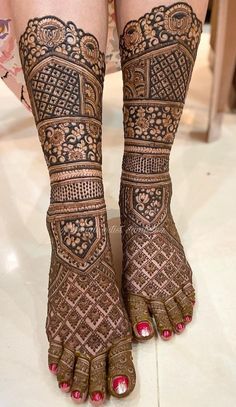 the legs and feet of a woman with henna tattoos