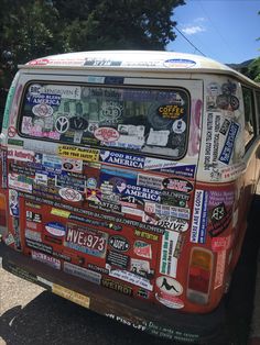 an old van covered in stickers and decals