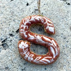 the letter s is made out of doughnuts and frosted with icing