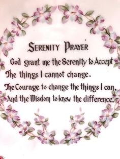serenity prayer with pink flowers and green leaves in the center on a white background