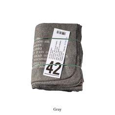 a gray blanket with the number 42 on it and a tag hanging from it's side