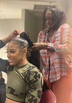 a woman is getting her hair done by another woman in the background with an instagramt