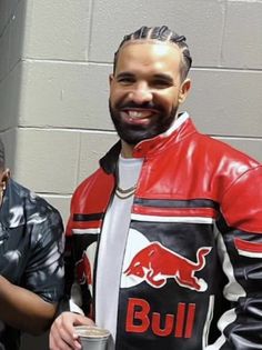 two men standing next to each other wearing leather jackets