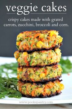 three crab cakes stacked on top of each other in front of some parsley sprigs