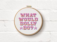 what would dolly do? cross - stitch pattern in pink and purple on white background