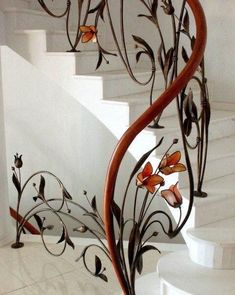 an artistic metal stair railing with flowers on it