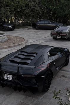 a black sports car is parked in a parking lot