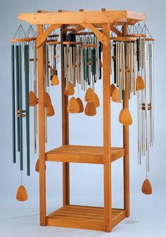 a wind chime with lots of musical instruments hanging from it's sides,