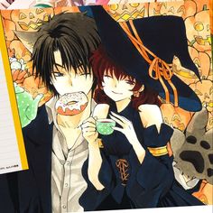 two anime characters eating donuts in front of pumpkins