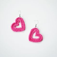 pink crocheted heart earrings on white background