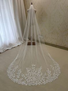 a white wedding veil with flowers on it