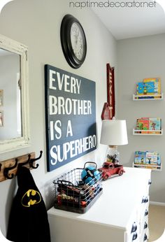 an image of a room with a batman sign on the wall and toys in bins