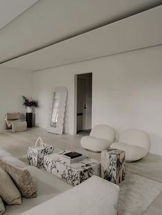 a living room filled with furniture and white walls