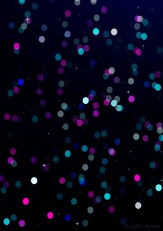 many different colored dots are floating in the dark night sky with stars and sparkles