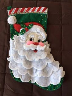 a christmas stocking hanging on the wall with santa claus's face in it