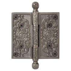 an ornate metal door handle on a white background