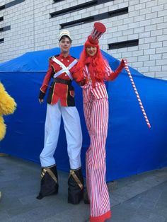 two people dressed in costumes standing next to each other
