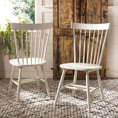 two white wooden chairs sitting next to each other