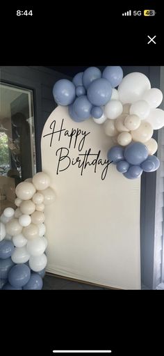 balloons and streamers are on the wall for a happy birthday