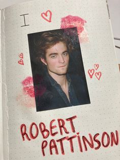 an open notebook with a photo of robert pattiinson on the front and inside