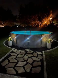 an above ground pool lit up at night