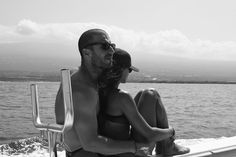 a man and woman sitting on the back of a boat