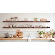 two wooden shelves above a kitchen sink filled with dishes