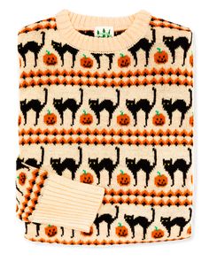 a sweater with pumpkins and black cats on it, next to a pair of gloves