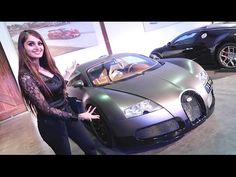 a woman standing next to a silver sports car