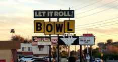 a street sign that says let it roll and bowl on the side of the road