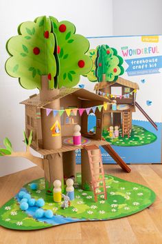 a cardboard model of a tree house on the floor