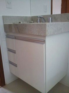 a bathroom sink with two faucets and a counter top in front of it