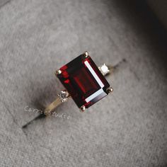 Solid gold emerald cut red garnet ring, pick 8*10mm breathtaking red garnet as center stone, match with one moissanite/CZ on each side, really beautiufl engagement ring, unique gift, if you're a fan of profound blood red color gemstone, don't miss this one. Main Stone: Natural Garnet Cut: Emerald Measurerment: 8*10 mm, about 3.5-4ct Side Stone: CZ/moissanite CSG086 Different gemstone can be customized, please feel free to contact if you have different idea; Engraving letter/number can be customi Garnet Stone Rings, Red Garnet Ring Vintage, Red Stone Engagement Ring, Emerald Ruby Ring, Emerald Cut Garnet Ring, Gold Ring Red Stone, Red Ruby Engagement Ring, Ruby Red Engagement Ring, Red And Gold Engagement Ring