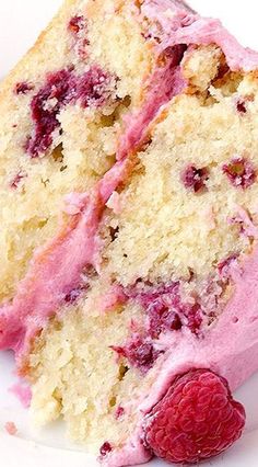 a close up of a piece of cake with pink icing and crumbs