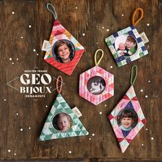 four ornament shaped ornaments with two children's faces hanging from them on a wooden table
