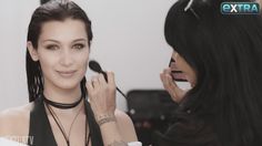 a woman is getting her make up done by another woman with long hair and piercings