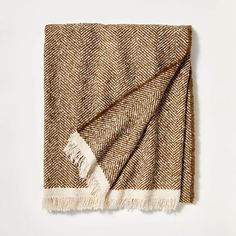 a brown and white blanket folded on top of a table