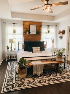a bed room with a neatly made bed and a rug on top of the floor