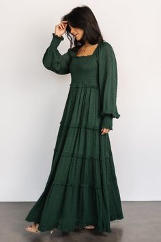 Embrace timeless charm in our smocked dotted maxi dress, featuring a rich evergreen shade. This dress beautifully combines classic elegance with modern design, making it a perfect choice for a standout and stylish look