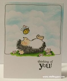 a card with a hedge laying on the ground and a bee flying over it that says thinking of you