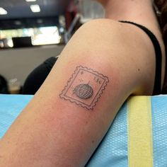 a woman's arm with a stamp on it and a globe in the middle