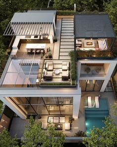 an aerial view of a modern house in the woods