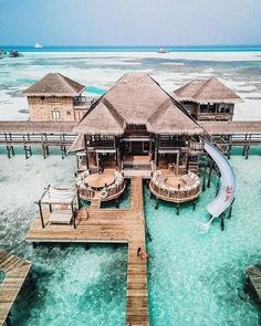 an aerial view of a water villa in the ocean