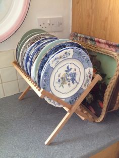 a stack of plates sitting on top of a wooden rack