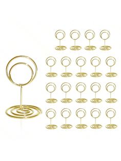 a bunch of gold rings and hooks on a white background