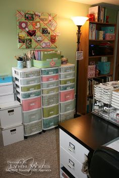 a room filled with lots of drawers next to a book shelf and lamp on top of a desk