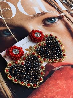 a magazine with an image of a woman's face and earrings on top of it