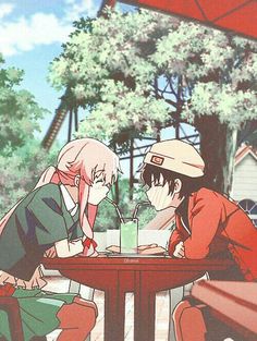 two people sitting at a table with drinks